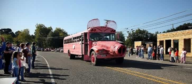 The famous pink hog bus on parade in downtown Ben Wheeler, Texas