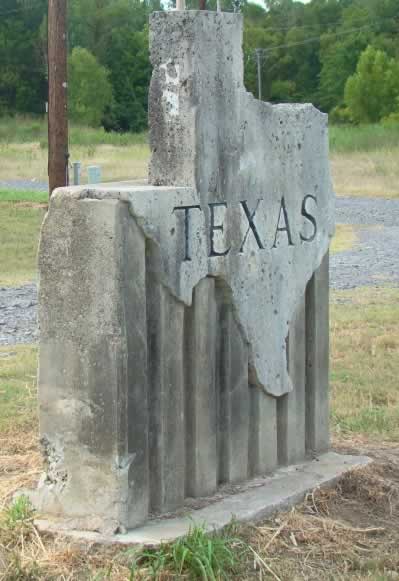 Concrete Texas state line marker near Waskom